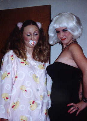 Me and Jaime this past Halloween.  I was a male transvestite...see my bulge? rrreeeoooowww...Jaime was my baby. I was her Mom-Daddy.